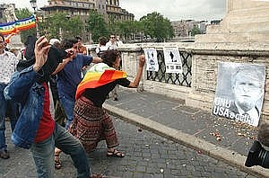 pacifisti italiani lanciano oggetti contro la foto di Bush